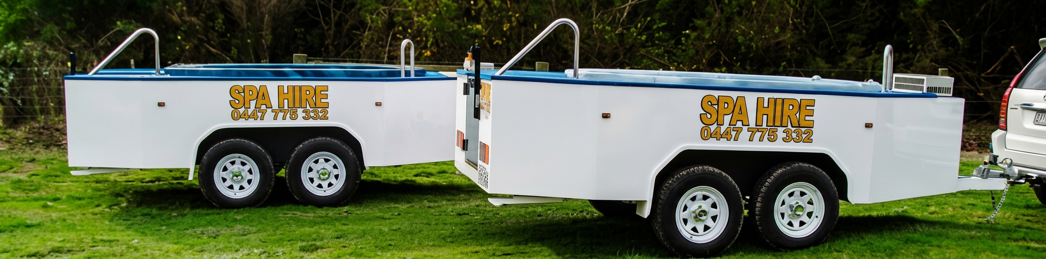 Two branded Langwarrin Spa Hire trailers with 0447 775 332 signage, ready for delivery.